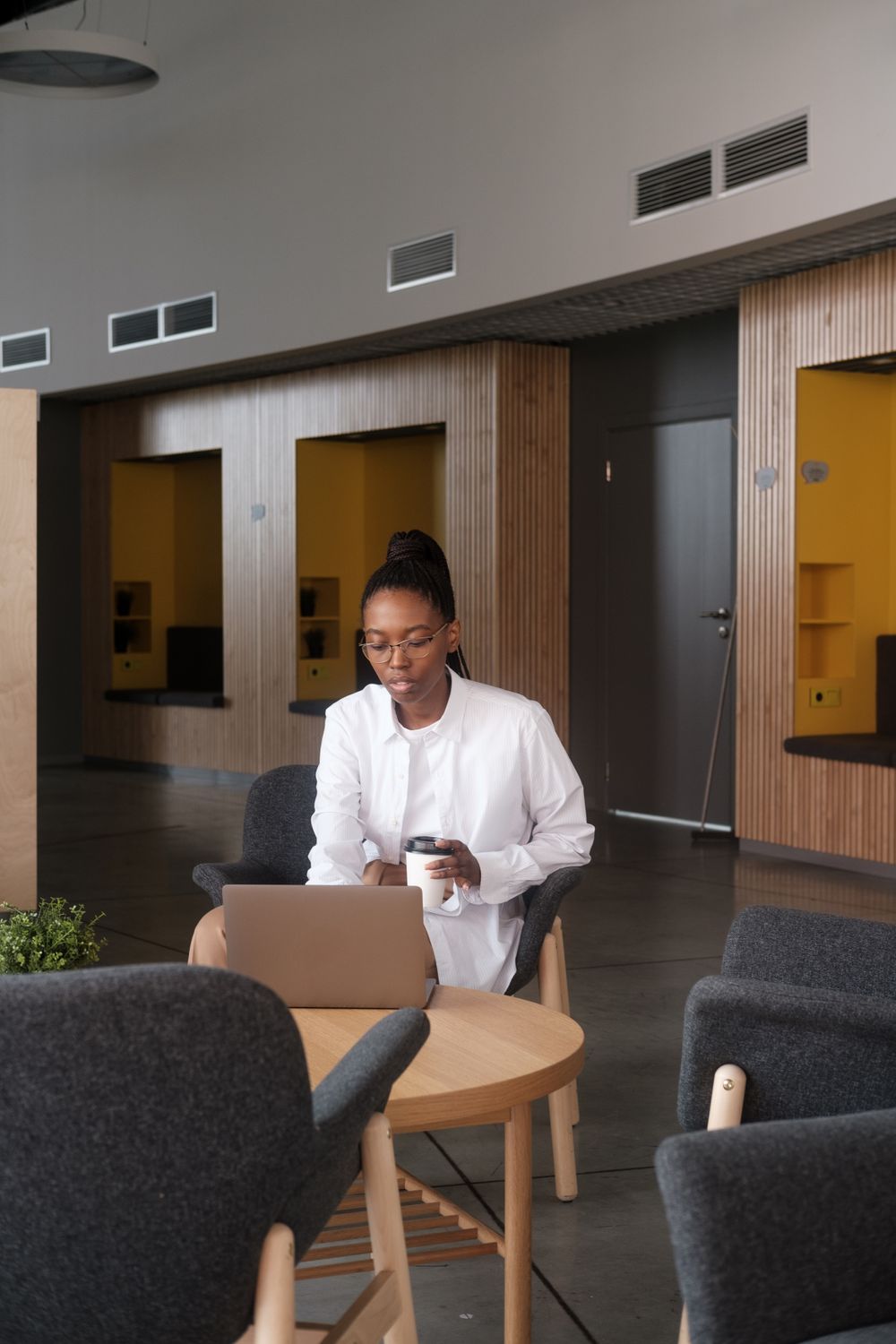 Woman working on a laptop in a shared workspace